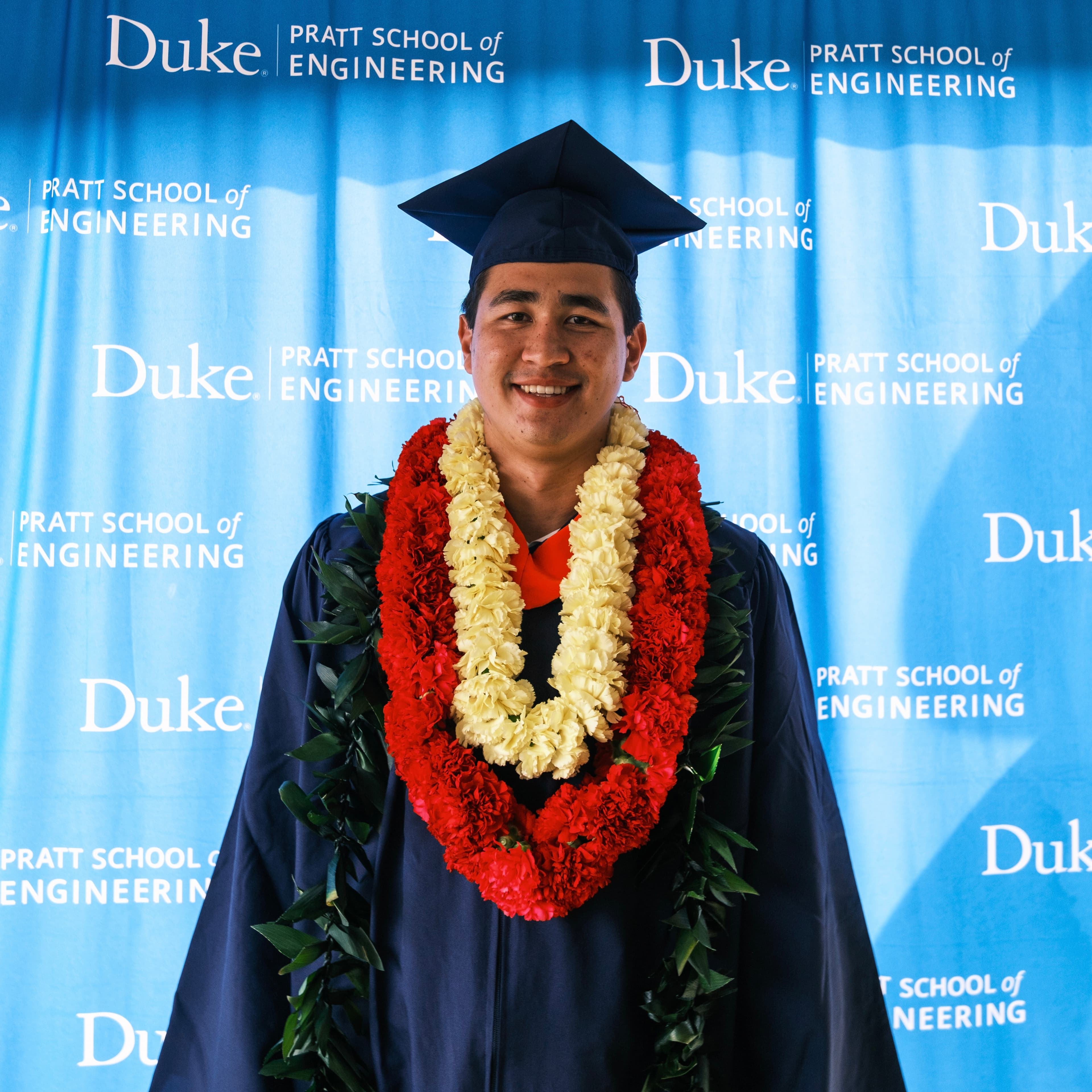 Andrew at Duke Pratt graduation wearing lei
